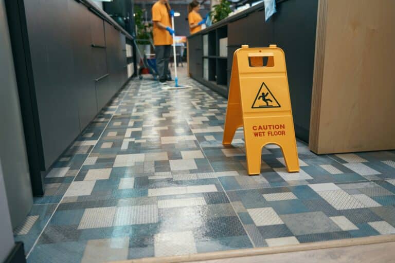 Warning sign Attention wet floor stands indoors on floor